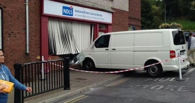 Van rolls down hill... and into a driving licence office