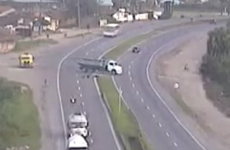 Watch this biker's incredible escape by sliding under a truck Hollywood-style