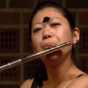 Butterfly lands on flautist's face mid-performance and she barely even blinks