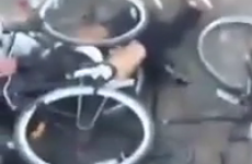 Drunk man gets totally entangled in a pile of bicycles