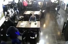 No one will ever be as cool as this guy casually sipping coffee during a brawl