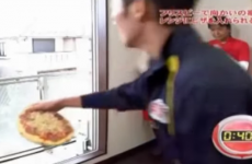 Lad throws a pizza into the oven from all the way across the street