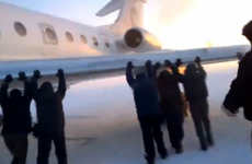 VIDEO: Passengers have to get out and push their airplane in the snow and ice