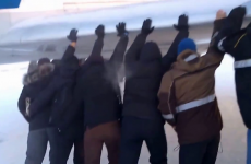 Watch Russian airline passengers push their frozen plane free from ice