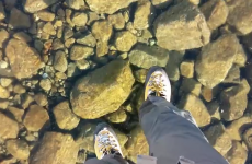 Watch two hikers walk out on an amazingly clear frozen lake