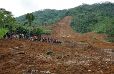 Woman searches for her children among 12 family members buried in landslide