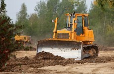 Man arrested after bulldozer and cash found in search