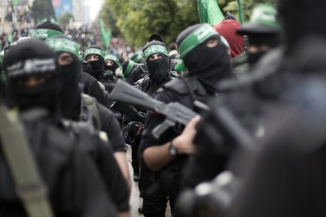 Palestinian Hamas masked gunmen display their military skills during a rally to commemorate the 27th anniversary of the Hamas militant group earlier this week.
