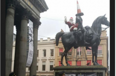 Uh oh. Santa's been arrested for climbing a giant horse statue