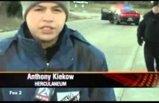 Cop has the uncoolest reaction ever when he realises he's in a live news shot