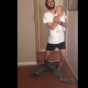 Baby-holding dad demonstrates how to successfully put on pants with no hands