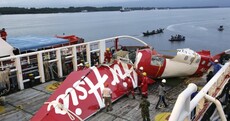 Bodies found belted to seats near AirAsia crash site