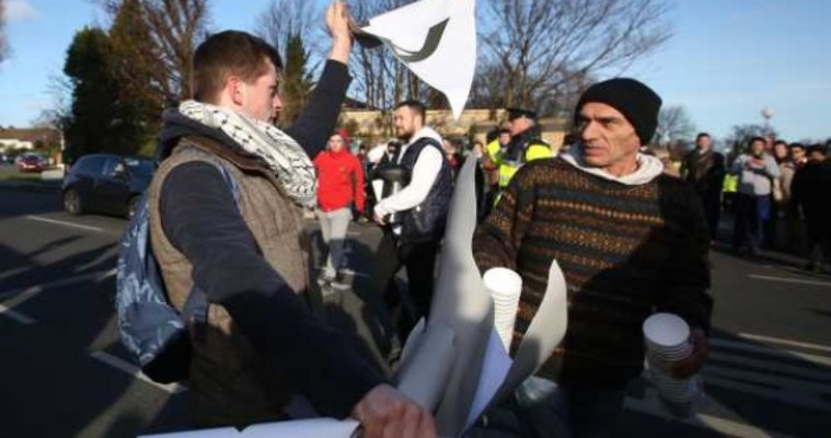 Protester tears up anti-Islam banner at Clonskeagh Mosque march