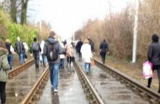 Passengers walk the track after power-cut stops some Luas trams