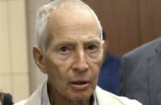 Billionaire fugitive arrested after saying on film that he "killed them all"