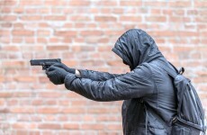 Woman shot in both legs outside house as she tried to escape from masked men