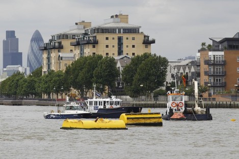 An emergency life boat, right, floats on the River Thames where a tugboat capsized and sank at Greenwich last week.