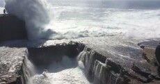 Watch: Amazingly, there was a paramedic just metres away - when this woman was swept off a cliff