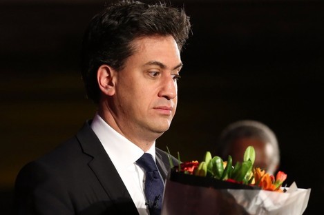Ed Miliband appears slightly afraid of some flowers he received at an event in London on Monday 