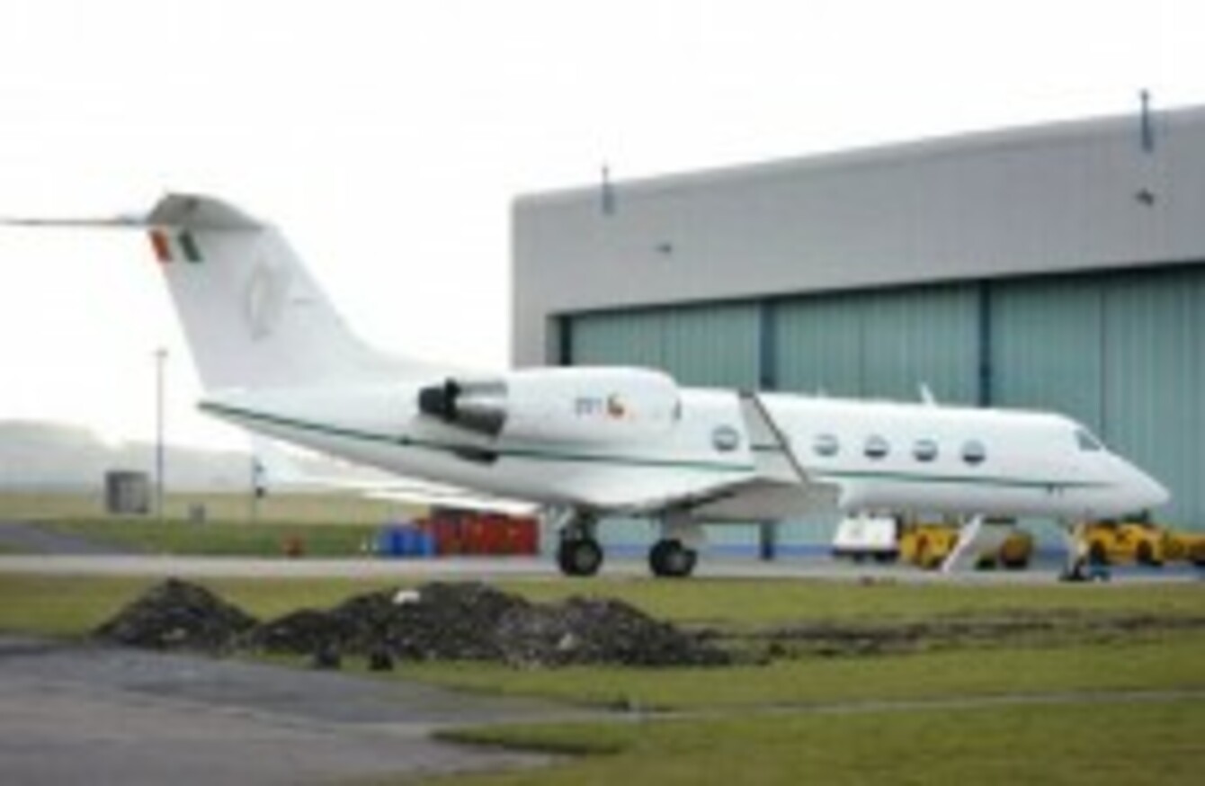 The Irish ministerial jet parked on an airfield tarmac under overcast skies.