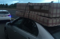 Driver caught on M50 with bed on roof, holding rope in their hands