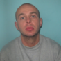 Armed robber released from prison by accident taunts police by posing with police van