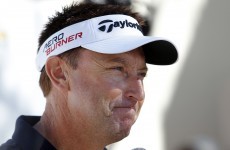 Robert Allenby has a fan carry his bag after sacking his caddie mid-round