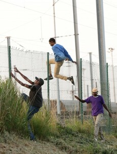 Riot police spray migrants with 'chemical irritant' as hundreds storm Channel Tunnel