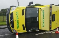 Ambulance with patient on board overturns after being hit from side