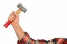 Man on the run after threatening bookies staff with hammer