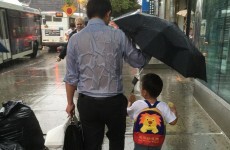 'Umbrella dad' is melting hearts all over the internet for selflessly sheltering his son