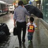 'Umbrella dad' is melting hearts all over the internet for selflessly sheltering his son