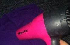 There's nothing wrong with using a hairdryer to dry/iron your clothes