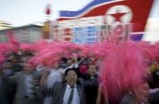 Loads of people are waving flags and flowers for Kim Jong-Un today