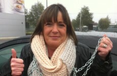 Mother chains herself to government gates to protest son's educational treatment