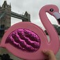 This guy went travelling with a pink flamingo bag, all to cheer up a stranger's girlfriend