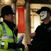 Thousands take to the streets in Guy Fawkes masks in centre of London