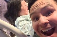 A new dad posed for a selfie with his wife giving birth in the background