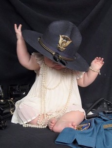 This photo of a baby girl wearing her fallen mother's police hat has gone viral