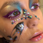 This makeup artist is sticking dead fish to her face