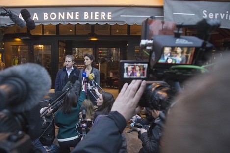 Audrey Bily, right, and Romain Debray, managers of A La Bonne Biere, speak to the media in front of the café today. 