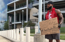 Out of work NFL player gets new job... by holding up a cardboard sign