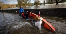 Pictures: the moment Joan Burton fell out of a boat in Kilkenny floods
