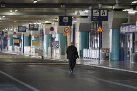 A man walks at the empty arrival terminal during a 12-hour work stoppage by air traffic controllers at the Athens International Airport.