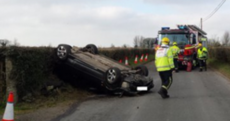 Car overturns after smashing into a speed limit sign