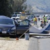 Woman killed after plane crashes into car