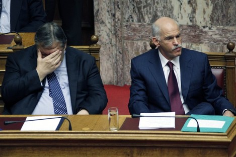 Greek Prime Minister George Papandreou, right, and Finance Minister Evangelos Venizelos react during a confidence vote meeting at the parliament in Athens, on Friday