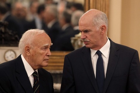 Greek Prime Minister George Papandreou, talking with the President Carolos Papoulias in June 2011