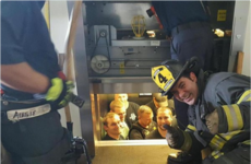 This photo of a fireman rescuing police officers stuck in a lift is pure gold