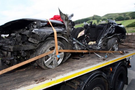 The black Volkswagon Passat, in which seven friends were killed, is removed from the scene in Donegal of the worst road accident on record.